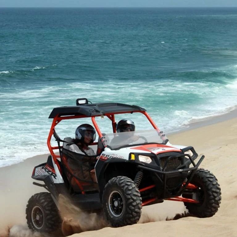 An off-road buggy on the dunes above the Pacific
