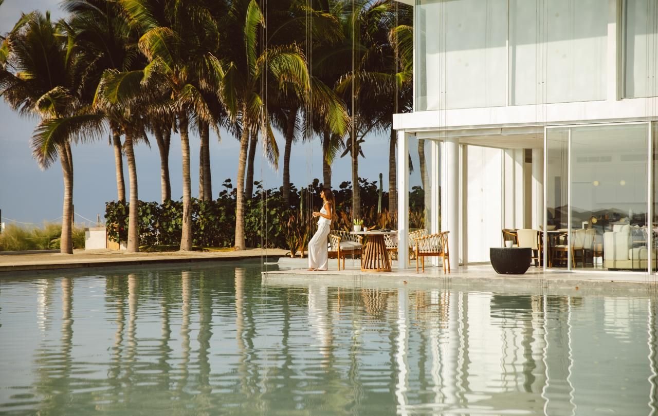 A guest by the reflecting pool at Viceroy Los Cabos